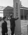 有明製鉄熊本製造所がスタート　看板を掲げる職員＝熊本市本山町