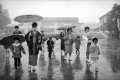 雨の入学式　お母さんと登校する新一年生＝熊本市の黒髪小学校