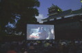 熊本城シネマウイーク　夕やみが迫る中、上映される「伊能忠敬」