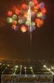 全国花火競技大会　夜空を彩る大輪の花火。後方の明かりは八代市