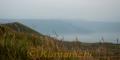 阿蘇谷にうっすらと広がる雲海。左手前は米塚＝１５日午前６時半ごろ、阿蘇市