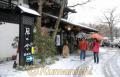 雪が舞う黒川温泉を歩く観光客＝南小国町